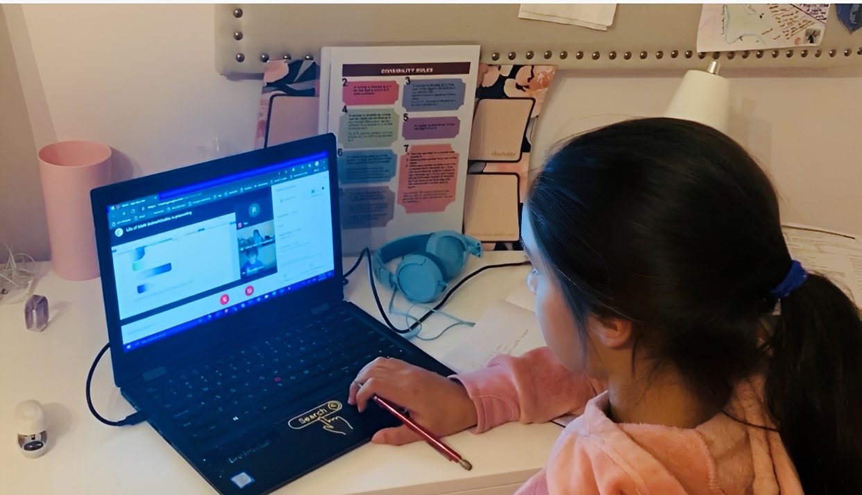 Girl studying online at her desk.