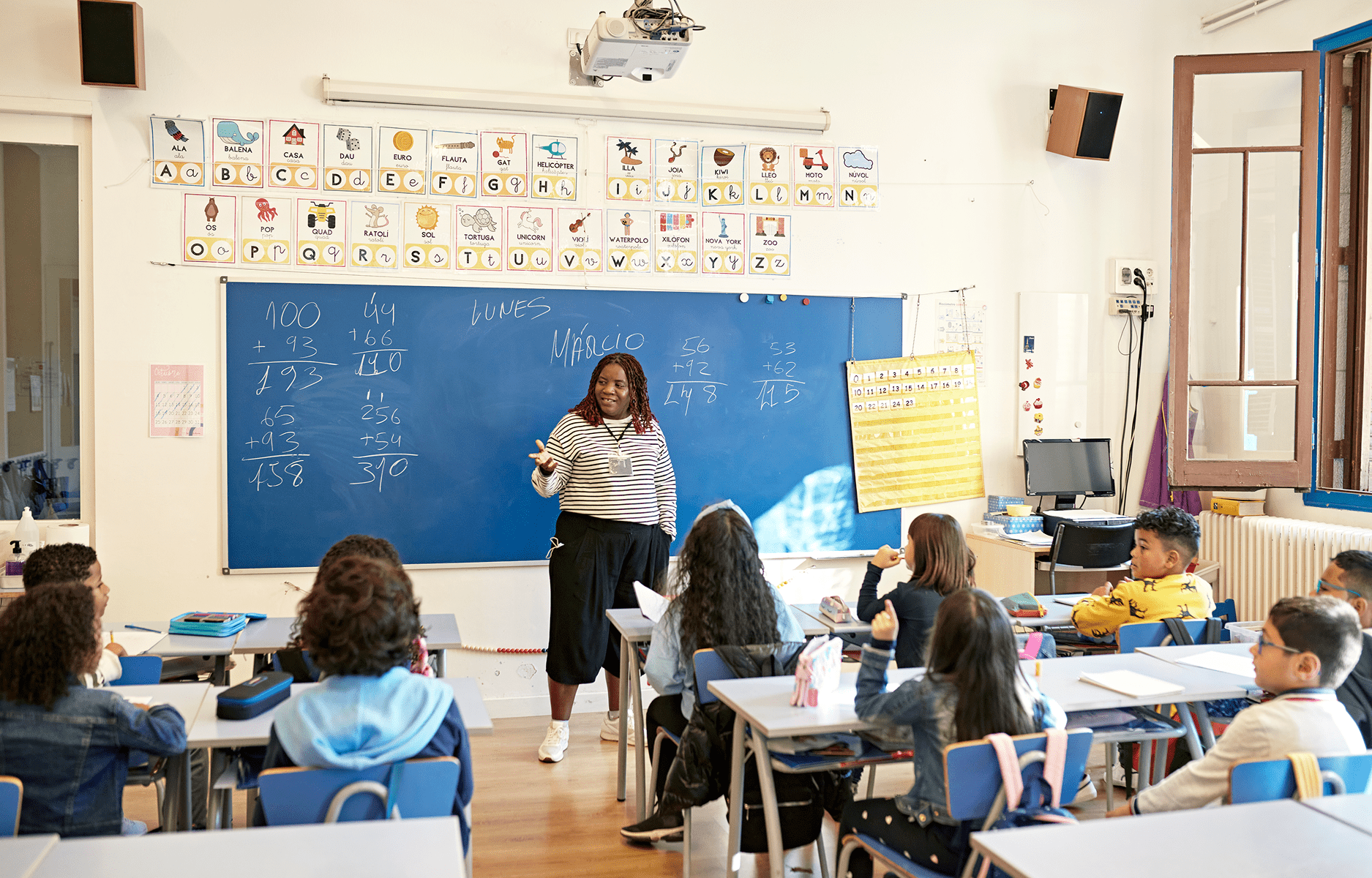 Classroom with teacher and attentive students learning.