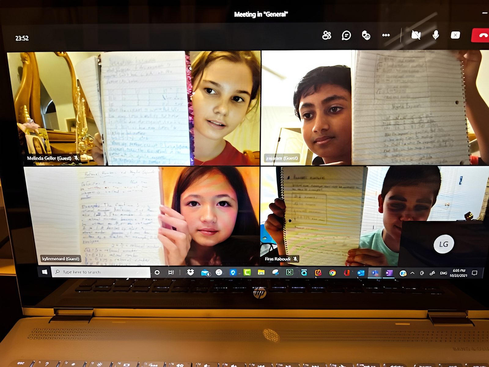 Video call with children showing notebooks.