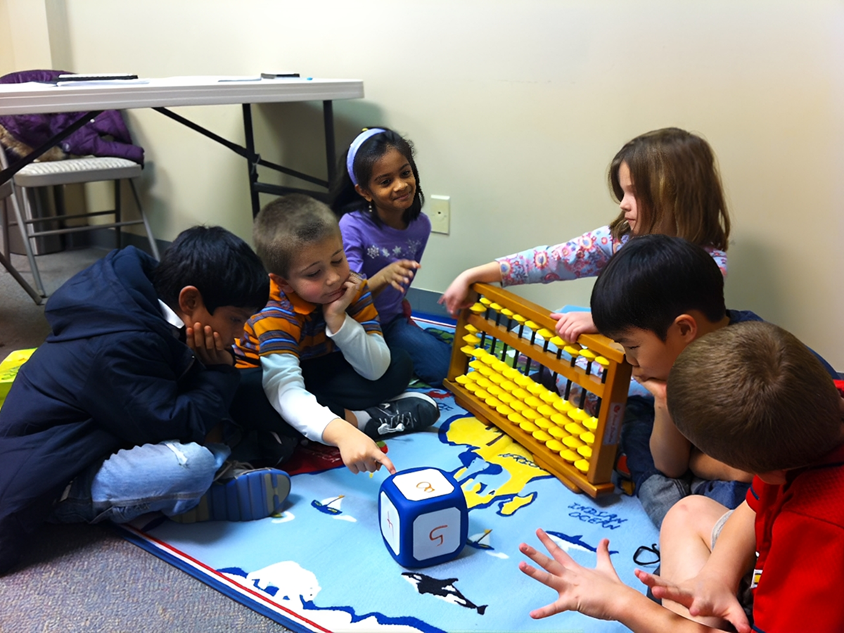 Children playing and learning with abacus together.